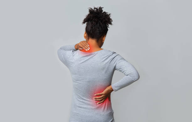 one lady are white t-shirt showing a back pain.